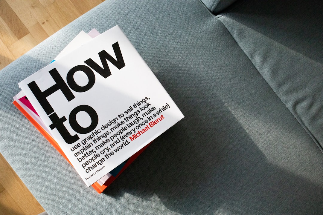 A pile of design books on a sofa