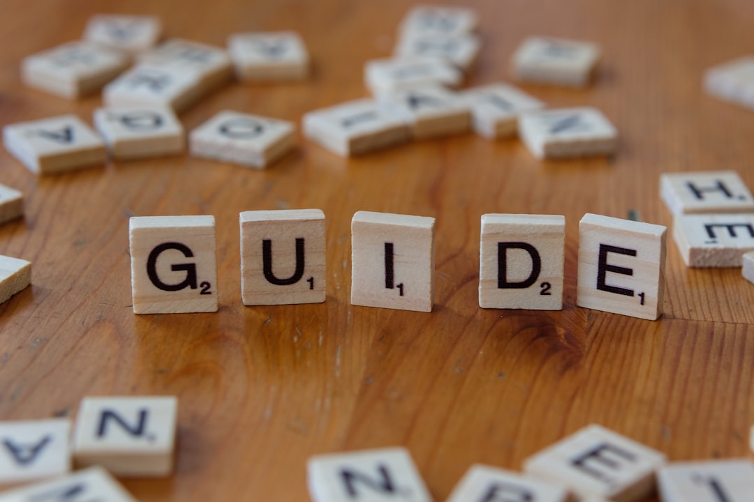 a-wooden-table-topped-with-scrabble-tiles-spelling-the-word-guide-ojoexopbvu8